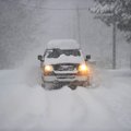 A truck makes its way down Ray Ave in Fayetteville after storm showers blanketed the area with snow ...