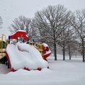 Snow covers the playground equipment at Happy Hollow Elementary School in Fayetteville Wednesday mor...