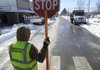 Chris Hook with the Bentonville Water Department stops traffic Friday while workers clear snow in downtown Bentonville. Mike Churchwell, city transportation engineer, said the city is fully stocked with sand and salt for the roads. The city spent $55,000 on overtime and material prior to last week’s snowstorm. The cost to clear last week’s snowstorm will not be available until Monday or Tuesday, Churchwell said.
