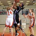 Fayetteville’s Sydney Conley, center, shoots the ball over Rogers Heritage’s Lindsey Wood during the...
