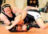 Bentonville’s Devin Asbill, top, works to get Fayetteville’s Dalton Ensly onto his back on Saturday during their 125-pound match in 7A-West Wrestling Tournament in Rogers. Asbill won the match.