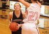 Fayetteville’s Sarah Smith drives the lane while being guarded by Bentonville’s Brittany Spychalski in Tiger Arena on Friday in Bentonville.