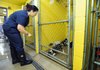 Nancy Howe of the Fayetteville Animal Shelter moves a group of puppies into a clean run Tuesday. Of the about 40 dogs housed in the building, only six came to the shelter from Fayetteville. The remainder were found in Washington County within the last week.