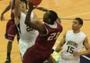Pulaski Academy’s Dusty Hannahs (left) and Chris Bruce defend Pine Bluff Dollarway’s Tevin Tyson (21) as he drives to the basket during the Bruins’ 72-50 victory over the Cardinals on Wednesday at the Class 4A South Regional. 