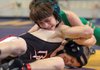 Josh Freeman (bottom) of Beebe wrestles of Coleman Brainerd of Oak Grove Saturday in the 103 lb class at the state high school wrestling tournament at the Jack Stephens Center in Little Rock. Freeman won the match.