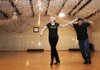 Meza Harris, left, takes dance lessons Feb. 24 from instructor Adam Richardson to prepare for the local Dancing with the Stars competition. The session was held at Arkansas Dance Connection in Tontitown.
