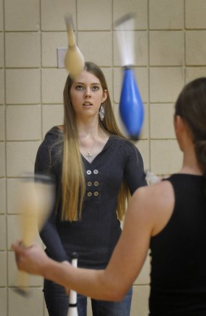Brittany Butler concentrates as she practices her juggling with Eric Jackson on Monday at the University of Arkansas HPER building. Both are in the Razorback Jugglers club.