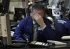 Specialist Christopher Culhane works Thursday at the New York Stock Exchange, where energy companies saw large drops. 