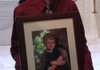 Tyler Nelson, of Bentonville, brother of Jonathan Nelson who was killed earlier this year when a soccer goal at his school fell on him, holds a photograph of his brother outside the House Committee on Public Health, Welfare and Labor in a March 10 file photo.