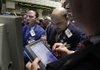 Specialist Michael Pistillo (left) works at his post Tuesday on the floor of the New York Stock Exchange. 
