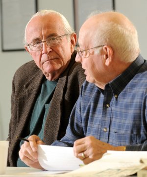 Bill Williams, left, listens to E.J. Miller, both Benton County election commissioners during a meeting Friday in Bentonville. Williams stepped down as chairman during the meeting and nominated Miller as his replacement. The commission’s newest member, Mike Sevak, became the commission’s secretary.