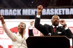 Mike Anderson (right) and his wife, Marcheita, "call the Hogs" during a news conference introducing Anderson as the new men's basketball coach inside Bud Walton Arena at the University of Arkansas in Fayetteville on Saturday.