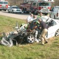 Authorities comb through the wreckage of a Hyundai Sonata after a collision claimed one life and slo...