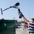 Cy Matulis from the Benton County Sheriff’s Office Inmate Work Program tosses an electric scooter in...