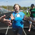 FINISH-LINE HIGH-FIVES Samantha Delancey, 13, of Bentonville is congratulated after crossing the fin...