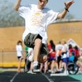 LOOKING AND LEAPING Daniel Tennison of Fayetteville makes his second attempt in the men’s long jump ...