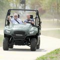 Capt. Rick McCurdy, left, holds on as firefighter Lance Selph drives an all-terrain vehicle through ...