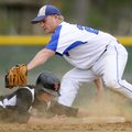 PICK OFF ATTEMPT Rogers High’s Jake Rylee, top, pulls down the throw from the plate while attempting...