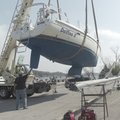 FINAL DESTINATION A 38-foot sailboat hangs suspended from a crane Friday at Beaver Lake while worker...