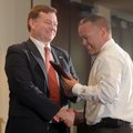 John Threet, left, Washington County prosecutor, gives Detective Robert Hendrix of the Springdale Po...
