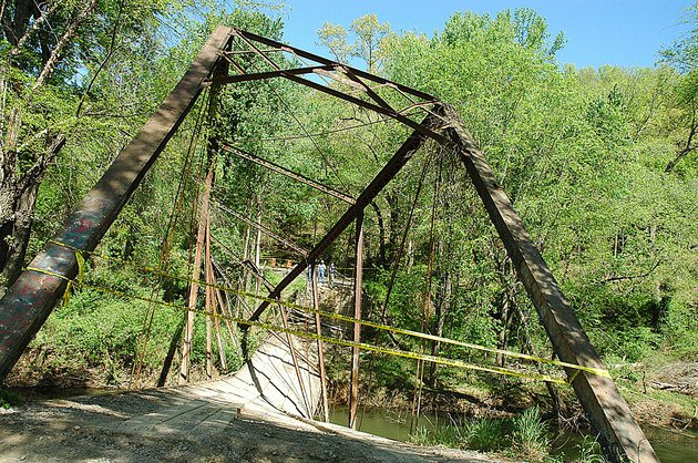 yellow-tape-blocks-an-entrance-to-the-historic-fryer-bridge-tuesday-april-12-2011-in-morrilton-ark-the-bridge-collapsed-after-the-driver-of-a-9-ton-truck-drove-over-the-structure-that-has-a-3-ton-weight-limit-the-fryer-bridge-is-a-metal-truss-thats-one-of-the-last-of-its-kind-in-the-state-the-state-highway-commission-says-its-the-oldest-bridge-that-was-still-in-service-in-arkansas
