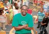 Antonio Moore, who raps under the name Tony Ocean, poses with pupils in his class of 3 year olds at Rockefeller Elementary in Little Rock, where versions of his profanity-free CD are offered in the classroom treasure chest. 