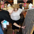 Natalia Greene, left, looks over a map of the race course on Thursday with volunteer Margot Henderso...