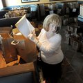 Margot Henderson finds a race entry in a bag on Thursday at the registration headquarters for the 13...