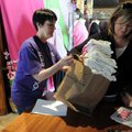 Race volunteer Sharon Baltz helps Kim Jack pick up registration information for her team, the Noah’s...