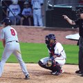 Home plate umpire Seth Buckminster signals to the pitcher during the Northwest Arkansas Naturals gam...