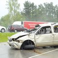 MINIVAN ROLLOVER Cpl. Eric Schrock with the Arkansas State Police Troop L photographs a 1999 Mercury...
