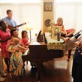 Farah Buck, middle, and her husband, Jeremy “Stuart” Buck, listen with their children Christine, Eva...