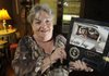 Patti Penny holds a photograph of her husband Al on Wednesday at her home in Bentonville. The couple had discussed organ donation prior to his death last July.