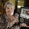 Patti Penny holds a photograph of her husband Al on Wednesday at her home in Bentonville. The couple...