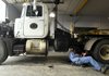 Josh Brenaman, a mechanic with the Benton County Road Department, works on a county equipment hauler Friday at the county’s shop in Bentonville.