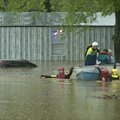 Residents of Oak Glen Residential Community are assisted by rescue personnel as rising waters from a...