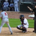 Home plate umpire Seth Buckminster signals to the pitcher during the Northwest Arkansas Naturals gam...