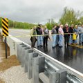 Benton County Judge Bob Clinard, in a black suit, along with other county officials cut a ribbon to ...
