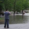 Daniel Conroy photographs the flooding on Megan Drive in Fayetteville on Monday. He said he was taki...