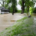 Butler County Sheriff Mark Dobbs stands on a levee along the Black River, right, Monday, April 25, 2...