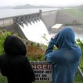 Krystle Petterson, left, and her brother Keith Petterson watch the Beaver Lake Dam release water thr...