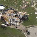 People stand near a destroyed house in Vilonia, Ark., Tuesday, April 26, 2011, after a tornado struc...