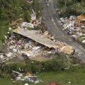 People walk on a road in Vilonia, Ark., Tuesday, April 26, 2011, after a tornado hit the area late M...
