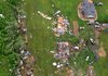 Vehicles, boats and other possessions are scattered among the debris of tornado-obliterated homes Tuesday in Vilonia. 