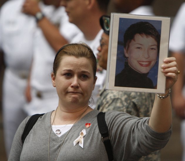 alyson-low-holds-a-photo-of-her-sister-911-victim-sara-low-an-american-airlines-flight-attendant-from-batesville-before-a-ceremony-at-new-york-citys-zuccotti-park-on-tuesday-sept-11-2007
