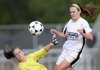 Bentonville’s Lauren Power, right, collides with Rogers High keeper Mary Eoff in front of the goal Tuesday during the Lady Tigers’ game against the Lady Mounties in Bentonville.