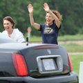 Residents Elaine Wade, from left, Susan Shore and Bob Moses greet the Dalai Lama as he is driven Tue...