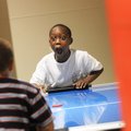 Taeshaun Clark, 7, watches as he makes a goal in a game of air hockey against Tyrique Scott, 7, at t...