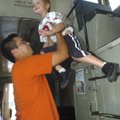 Chris Medrano of Rogers helps his son, Jaydon, 4, down from the crow’s nest of the Frisco caboose Tu...
