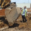 Tommy Wallace with the Rogers Street Department removes an underground telephone line Tuesday from t...